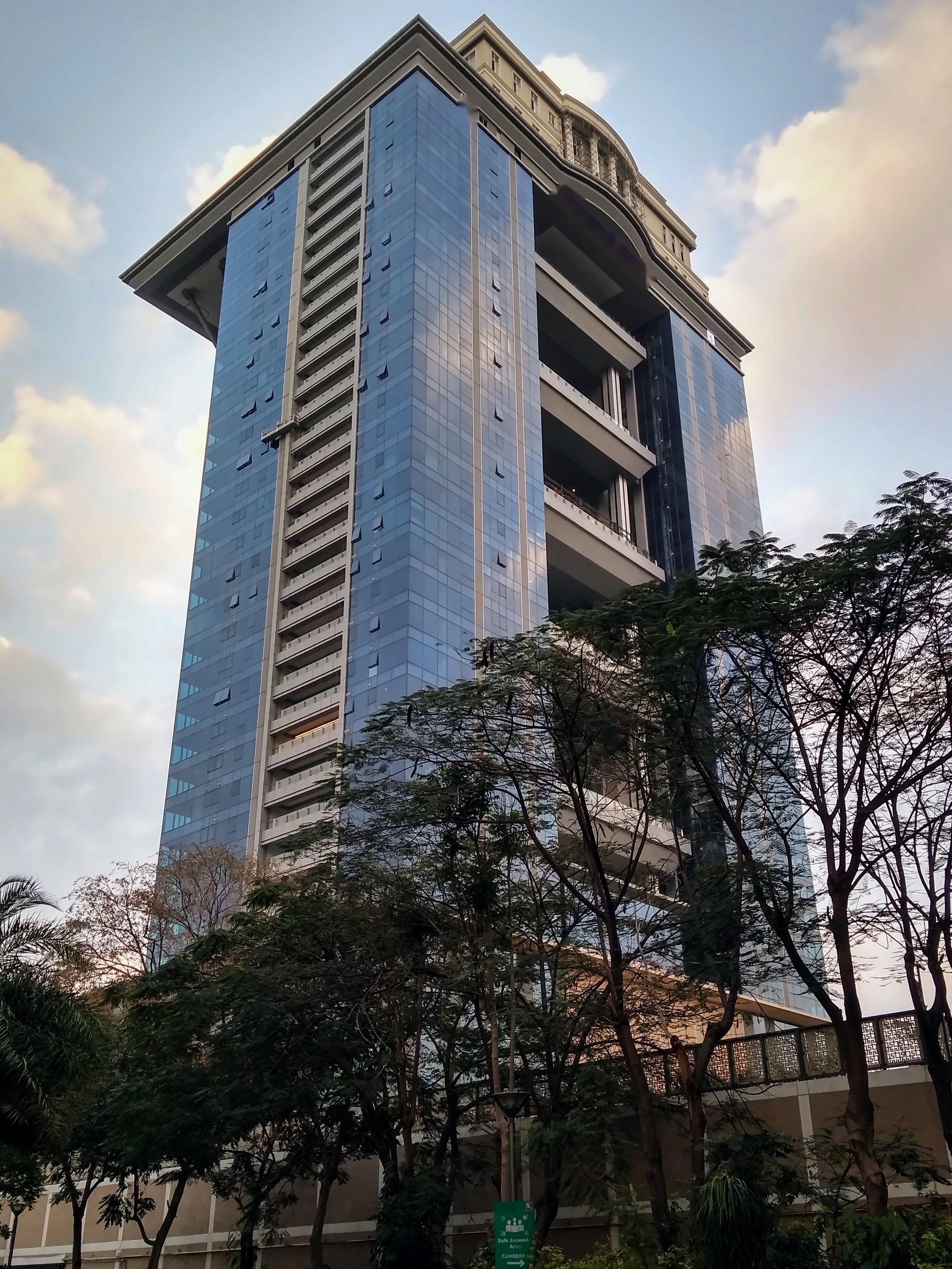A glass office tower in central Bengaluru against an evening sky