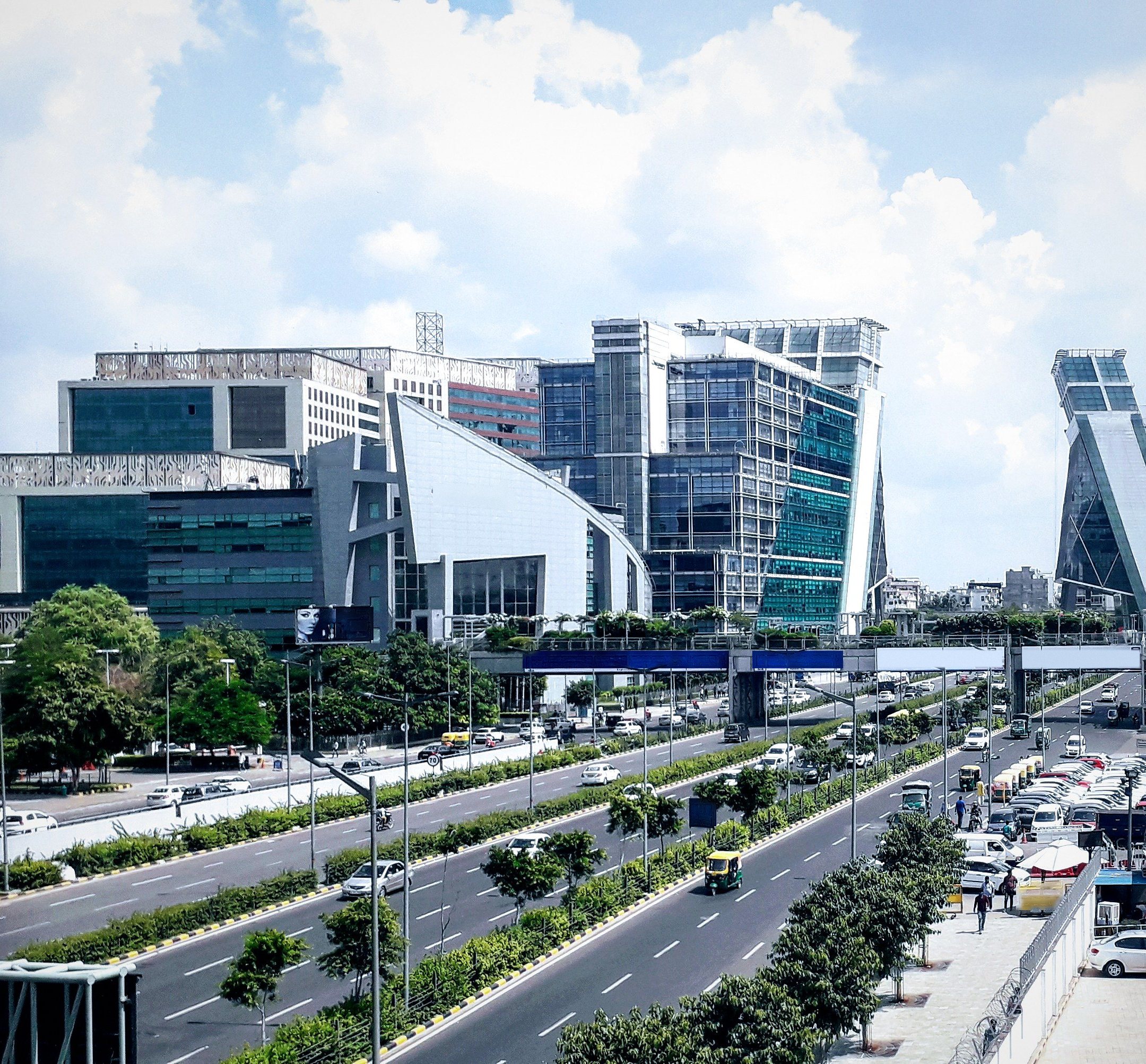 Glass office towers of Cyber City, Gurugram, beside the expressway